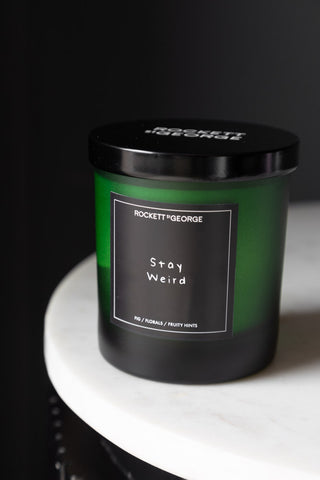 Lifestyle image of the Rockett St George Green Stay Weird Scented Candle with lid