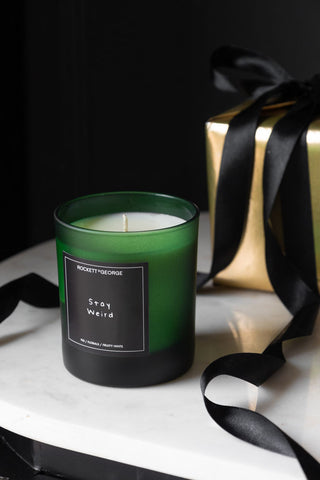 Lifestyle image of the Rockett St George Green Stay Weird Scented Candle with gift box