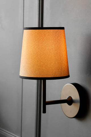 Lifestyle image of the Tapered Linen Shade Wall Light close up