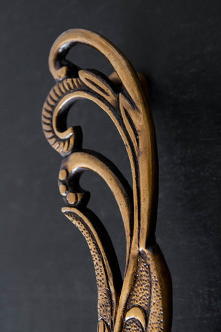 Close up of Set Of Feathers of Art Deco Brass Swan Door Handles on a cupboard