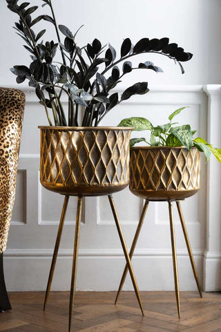 Lifestyle image of the Set Of 2 Antique Brass Planters On Stand