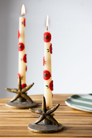 Lifestyle image of the Set Of 2 Red Flower Tapered Candles