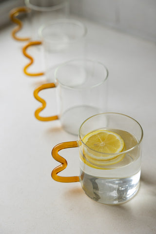Close-up image of the Set of 4 Amber Wavy Handle Glass Mugs