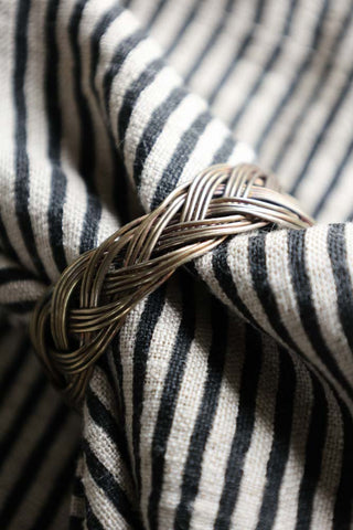 Image of the plaited design from the Set Of 4 Individual Design Brass Napkin Rings