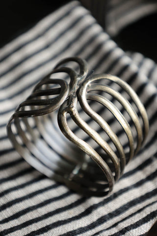 Close-up image of one design from the Set Of 4 Individual Design Brass Napkin Rings