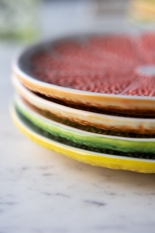 Detail image of all 4 of the Set Of 4 Grapefruit Plates showing the plate texture