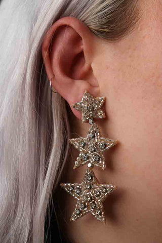 Image of the Trio Silver Beaded Star Earrings on an ear