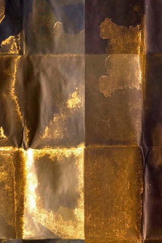 A detail image of gold and bronze tile patterned wallpaper.