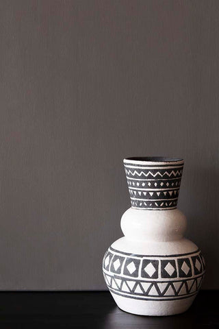 A bold modern black and white vase photographed in front of a wall painted in Raeburn paint.