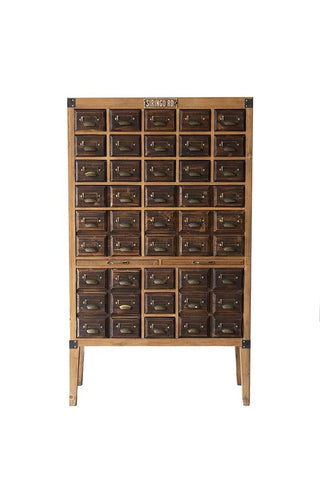 Cut out image of the apothecary style many drawer unit made from wood with brass handles. 