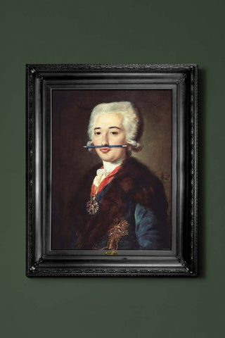 lifestyle image of the blue pencil canvas with printed frame coloured portrait with blue pencil in mouth and black frame on green wall background