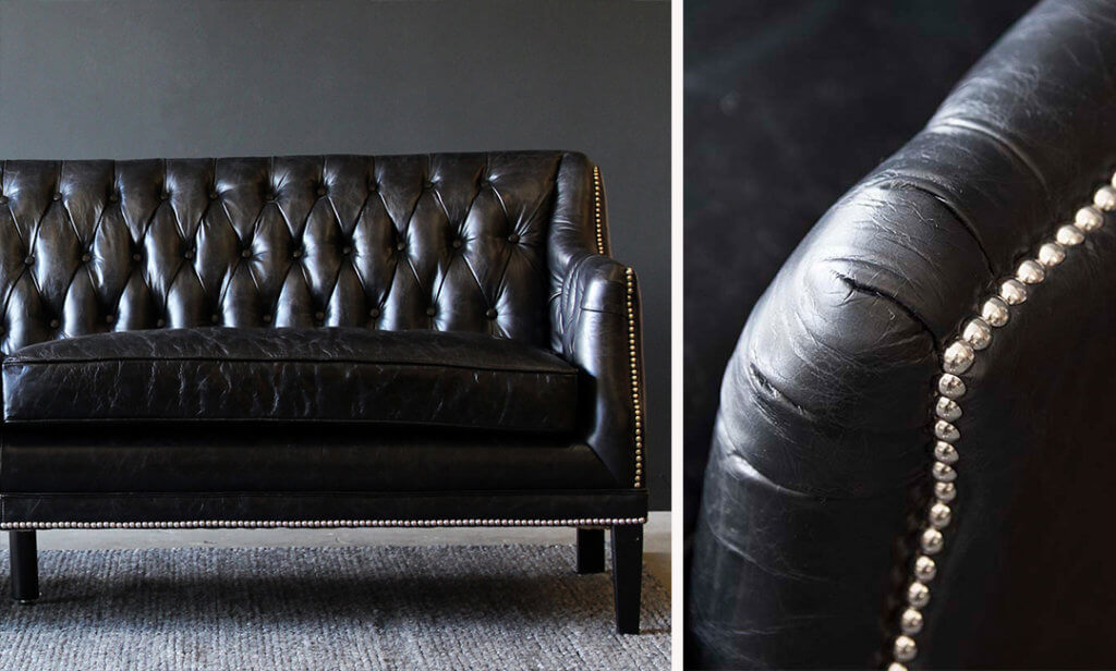 close-up of black leather chesterfield sofa