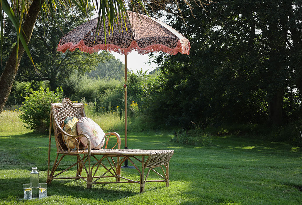 beautiful cane sun lounger and parasol