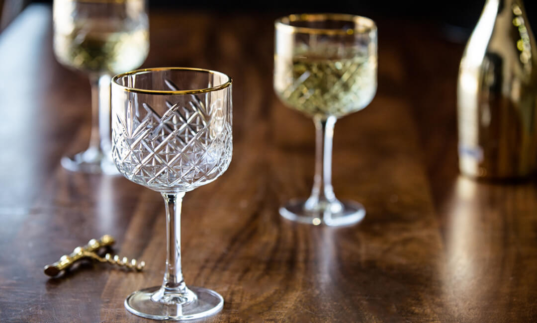 image of vintage style cocktail glasses on a wood table