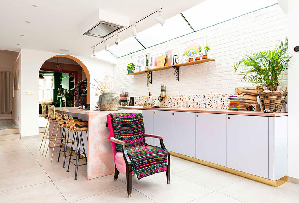 white and pink kitchen with boho armchair